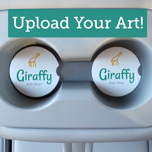 May include: Two white round coasters with a green and yellow giraffe design and the text "Giraffy Kids Wear" on each.