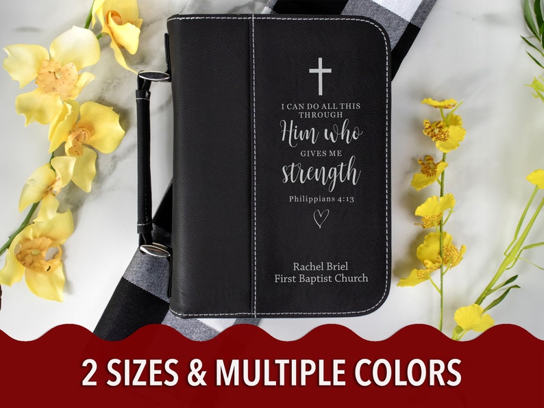 May include: Black leather-bound journal with a silver cross and the quote "I can do all this through Him who gives me strength Philippians 4:13" engraved on the front. The journal also has the name "Rachel Briel" and "First Baptist Church" engraved on the front.