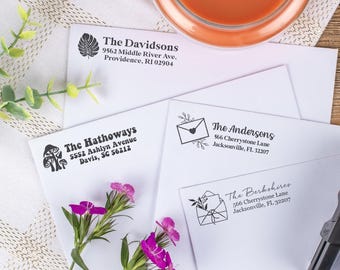 May include: Four white envelopes with black return address labels. The labels feature different designs, including mushrooms, a leafy plant, and a stylized envelope with a heart. The text on the labels includes names and addresses, such as "The Davidsons", "The Hathoways", "The Andersons", and "The Berkshires".