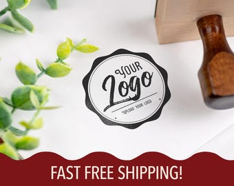 May include: A white card with a black and white circular stamp that says "Your Logo" with the text "Upload Your Logo" underneath. The card is on a white surface with green leafy branches in the background. The text "FAST FREE SHIPPING!" is at the bottom of the image.