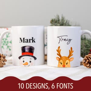 May include: Two white ceramic mugs with Christmas-themed designs. One mug features a snowman with a black top hat and the name "Mark." The other mug has a reindeer design and the name "Tracy." The text "10 DESIGNS, 6 FONTS" is at the bottom.