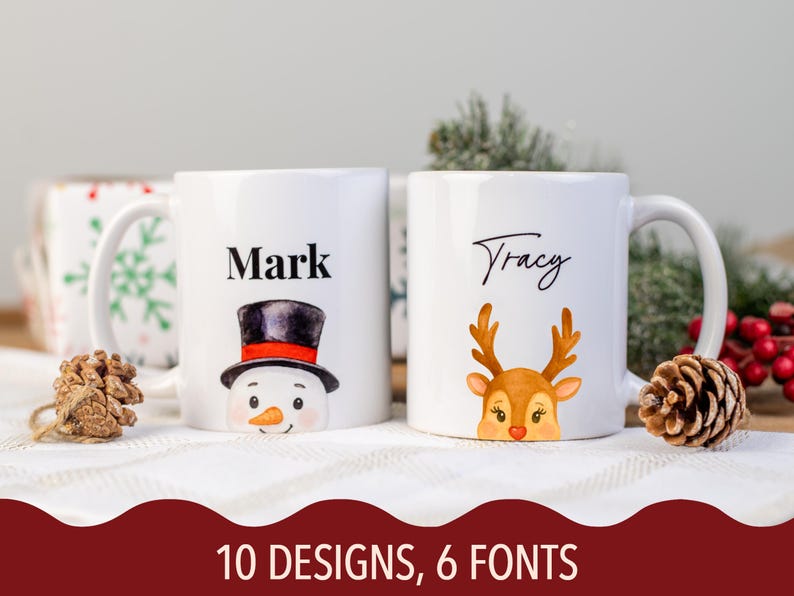 May include: Two white ceramic mugs with Christmas-themed designs. One mug features a snowman with a black top hat and the name "Mark." The other mug has a reindeer design and the name "Tracy." The text "10 DESIGNS, 6 FONTS" is at the bottom.
