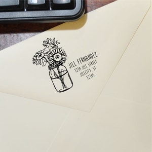 May include: A black and white illustration of a mason jar filled with sunflowers. The text "JILL FERNANDEZ 1234 JILL STREET JILLCITY, ST 12345" is below the image.