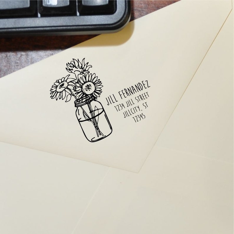 May include: A black and white illustration of a mason jar filled with sunflowers. The text "JILL FERNANDEZ 1234 JILL STREET JILLCITY, ST 12345" is below the image.