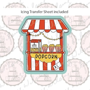 May include: A popcorn stand cookie cutter with a red and white striped awning and base. The design features a popcorn machine, three popcorn containers, a string of lights, and a yellow sign that reads POPCORN with a small tag labeled $1.