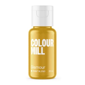 May include: A bottle of Colour Mill Glamour paint blend. The bottle is a golden yellow color with a white cap. The text "COLOUR MILL" is printed in white, with "Glamour" and "PAINT BLEND" below it. The bottle contains 20 mL of paint.