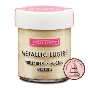 May include: A small glass jar of edible metallic lustre in vanilla bean color. The jar has a white lid and a pink label that says "Sweet Sticks" and "Metallic Lustre". The label also says "Vanilla Bean", "4g 0.14oz", and "100% Edible".
