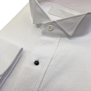 May include: A white dress shirt with a button-down collar and a textured fabric. The shirt has a single button on the front and two buttons on the cuffs.