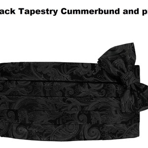 May include: Black tapestry cummerbund and pre-tied bow. The formalwear set features a detailed, swirling pattern. The cummerbund is pleated and the bow is pre-tied. The text "Stunning Black Tapestry Cummerbund and pre tied bow" is at the top.