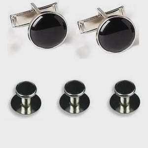 May include: A set of formalwear accessories, including two pairs of silver cufflinks and five shirt studs. Each piece features a round, glossy black center set in a silver-toned metal.