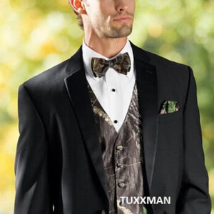 May include: A black tuxedo jacket with a camouflage patterned waistcoat and bow tie. The waistcoat has a TUXXMAN label.