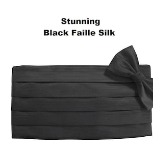 May include: A black faille silk cummerbund and bow tie set. The cummerbund is pleated and rectangular. The bow tie is pre-tied. The text "Stunning Black Faille Silk" is at the top.