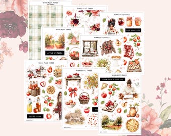 May include: A collection of decorative sticker sheets with an autumn theme. The sheets feature illustrations of apples, apple picking scenes, and fall-themed elements. The text "NIKKI PLUS THREE" and other phrases are visible.