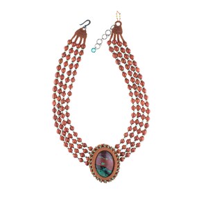 May include: A multi-strand necklace made of brown beads with a large oval-shaped gemstone pendant. The gemstone is a mix of red, green, and brown colors.