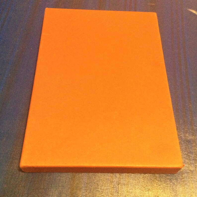 May include: A solid orange canvas board, ready for painting.