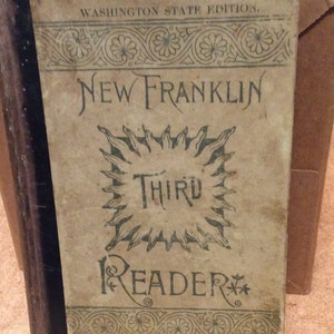 May include: A vintage book cover with the title "New Franklin Third Reader" in a green and brown color scheme. The cover features a stylized sun with the word "Third" inside. The book is from the Washington State Edition.