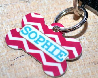 May include: Pink and white chevron dog tag with a turquoise name tag that says "SOPHIE".