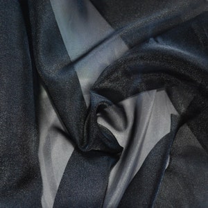 May include: Black sheer fabric with a subtle sparkle. The fabric is draped and folded, showing its texture and drape.