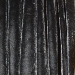 May include: Black velvet fabric with a vertical ribbed texture.