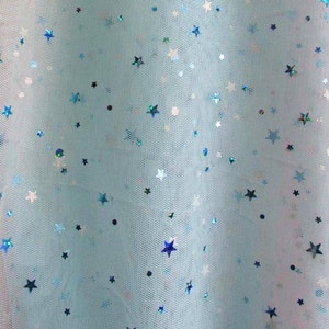 May include: Light blue tulle fabric with scattered iridescent blue stars.