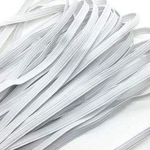 May include: A close-up of a bundle of white elastic cord. The cord is thin and flat, and it is arranged in a neat pile.