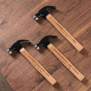 May include: Three claw hammers with black metal heads and light wood handles. Each handle features laser-engraved text: Love BUILDING memories with you, DAD! Love, Caden & Jaxon; Love you Forever... and a Day, Love, Benny & Aida; Dad, thanks for helping me build my life! Love, Alex, Elle & Kyler.