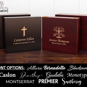 May include: Wooden keepsake boxes with engraved text and cross designs. One box is black with a gold cross and the name "Cameron Elliot" and date. Another is red with a cross design and the name "Jessica Thompson" and date. Font options are listed below.