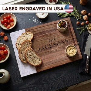 Custom laser engraved walnut and marble cutting board with family name and date, personalized wooden charcuterie board gift for weddings, housewarmings, anniversaries, and couples, made in the USA.