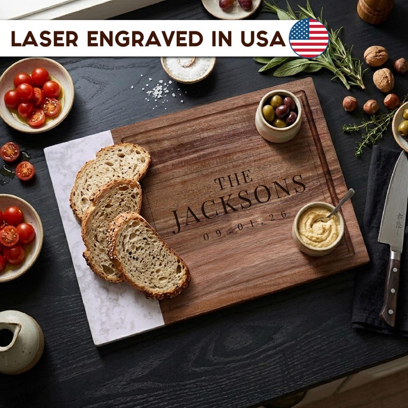 Custom laser engraved walnut and marble cutting board with family name and date, personalized wooden charcuterie board gift for weddings, housewarmings, anniversaries, and couples, made in the USA.