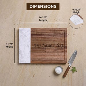 Large personalized acacia wood and marble cutting board measuring 16.375 x 11.75 inches with a 0.5625-inch thickness. Custom laser engraved charcuterie board ideal for food preparation, serving, and personalized gift giving.