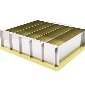 May include: A rectangular soap cutter with a light yellow base and silver metal sides. The interior is divided into five sections with a gold finish. The cutter is designed for even soap bar slicing.