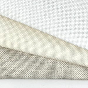 May include: A close-up of three fabric swatches in varying shades of white, cream, and gray. The fabrics have a textured, woven appearance, with visible threads creating a subtle grid pattern. The swatches are layered, showcasing the different colors and textures.