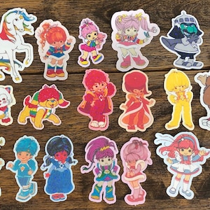 May include: A set of 15 colourful stickers featuring characters from the 1980s cartoon series, The Care Bears. The stickers feature a variety of characters, including the Care Bears themselves, as well as their friends and enemies. The stickers are all in a cartoon style and are perfect for adding a touch of nostalgia to any project.