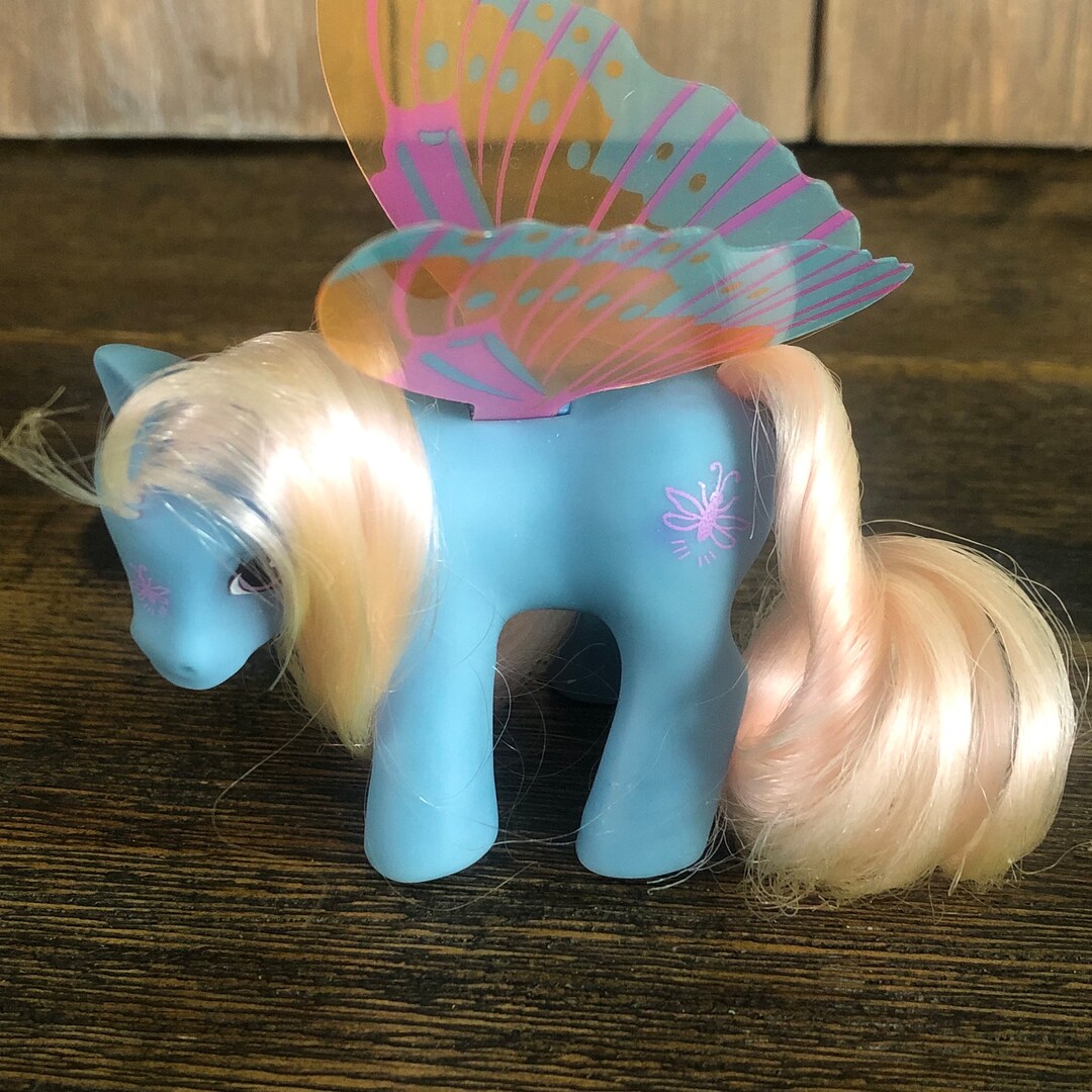 A lavender My Little Pony character with flowing teal and pink hair