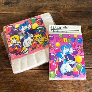 May include: A stack of white paper napkins and a package of party invitations. The napkins have a pink border and a colorful print of cartoon cats and balloons. The invitations are pink with a cat and balloon design and the text "PARTY!"