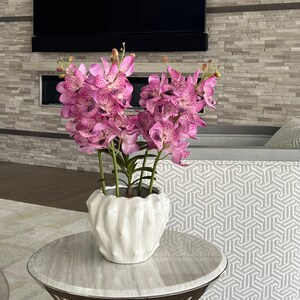 Pink orchids, orchid arrangement, tropical flowers, floral arrangement.