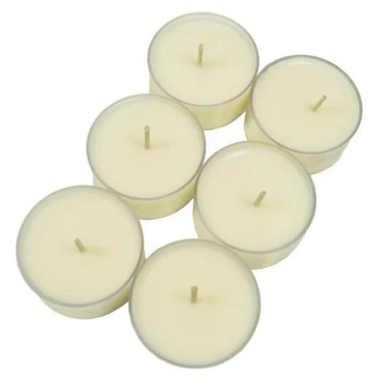 May include: A set of six white tea light candles in clear plastic containers. The candles are arranged in a circular pattern.