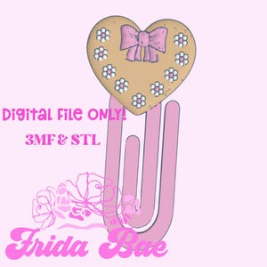 May include: A pink paperclip design with a heart-shaped top. The heart is tan with a pink bow and white and pink flower accents. Text on the image reads "Digital File ONLY! 3MF & STL" and "Frida Bae".