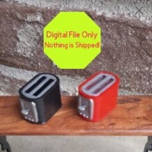 May include: Two miniature toasters, one black and one red, are displayed on a wooden surface.  The toasters have a silver accent on the front.