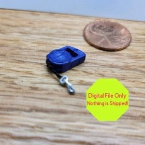 May include: A small blue plastic toy telephone with a silver cord and hook. The toy is about the size of a U.S. penny.