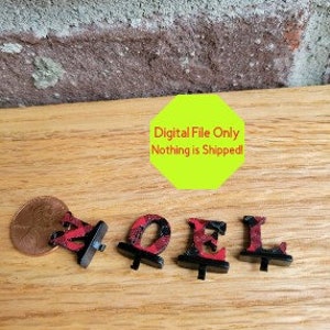 May include: Four black and red patterned letters spelling "2021" with a black base. The letters are about the size of a US penny.