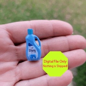 May include: A miniature blue plastic bottle with a white label that says "Downy" in a white font. The bottle is a replica of a fabric softener bottle.