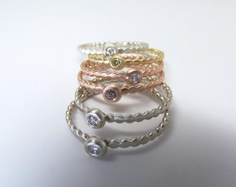 Solitaire diamond pebble rings set with diamonds or sapphires. Rose gold, white gold, yellow gold, or sterling silver in size 6.