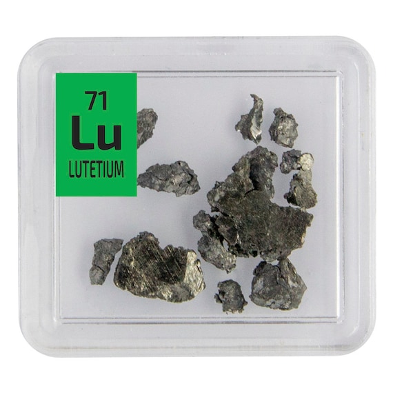 An actual chunk of rare-earth Lutetium metal displayed in a custom element tile — you are literally buying a piece of a real element most people have never heard of.