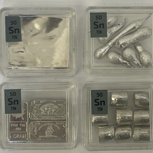 May include: Four clear plastic containers each containing 50 grams of tin metal. The containers are labeled "50 Sn TIN". The tin is in different forms: a sheet, small pieces, a bar, and small cylinders.