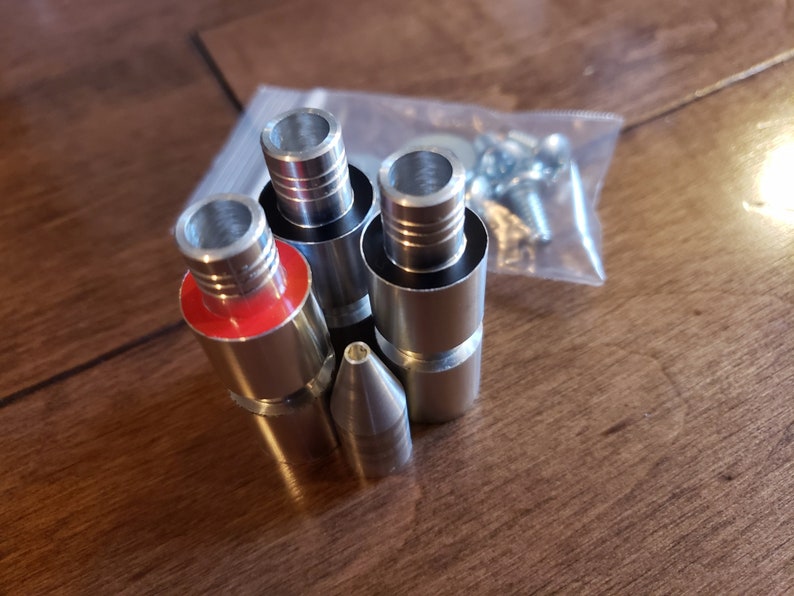 May include: A set of five silver metal attachments for a pipe, including a pointed tip and four different sized connectors with red rubber rings.