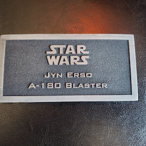 JYN ERSO A-180 Blaster name plate
