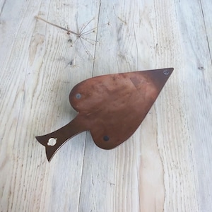 May include: A heart-shaped wooden serving tray with a handle. The tray is made of dark wood and has a natural finish.