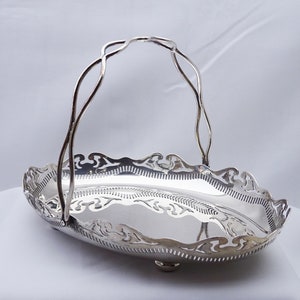 Corbeille à fruits antique en métal argenté. Panier ovale en métal argenté percé avec anse, pieds pour petits pains, support à gâteaux, corbeille à pain, bol de noix
