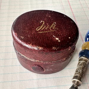 A vintage Victorian travelling ‘campaign’ leather ink well with beautiful brass engraved detail and glass well. Very collectible! c1800s.